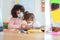Teacher using tablet with children in preschool during coronavirus outbreak - Back to school and covid-19 lifestyle - Focus on