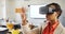 Teacher using virtual reality headset and digital tablet in classroom
