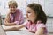 Teacher Watching Schoolgirl Use Laptop