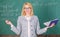 Teacher woman with book chalkboard background. Why teacher quit off sick with stress. Overwork and lack of support