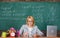 Teacher woman sit table classroom chalkboard background. Create and distribute educational content. Promoting