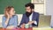 Teachers couple in classroom. Happy casual girl student with bearded hipster teacher over blackboard background