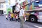 Teachers and a group of a preschool children in front of parked open colorful book bus