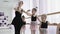 Teachers show how to dance to little ballerinas. Girl dancer in ballet school learns to dance. Young ballerinas jumping