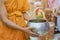 Teachers and students together make merit to give food offerings to a Buddhist monk on important religious days