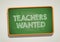 TEACHERS WANTED written in chalkboard. Conceptual image with word TEACHERS WANTED.