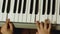 Teaching a child to play a musical instrument theme. Close-up of childrens fingers playing the piano. Development of musical talen
