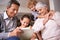 Teaching the grandparents some new tricks. A shot of two kids and their grandkids using a digital tablet while sitting