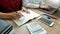 Teaching helping technology concept. Woman young teacher or tutor with adult students in classroom at desk with papers, laptop