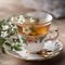 A teacup with a delicate floral pattern, steeping fragrant herbal tea2