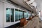 Teak bench and teak lined Promenade Deck of modern cruise ship on a grey stormy day