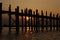 Teak bridge U Bain in Burma. Sunset, silhouettes.