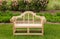 Teak chair or bench on green lawn