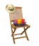 Teak deck chair with hat and drinks