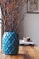 Teal blue moroccan vase with dried berry stick arrangement