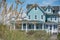 Teal coastal beach house with seagrass in the foreground