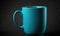 a teal colored coffee cup sitting on a black surface