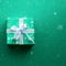 Teal green square gift box wrapped in red paper with a white ribbon bow against a red snow background.