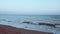 Teal and orange view at sunset on a sandy beach in Costa dorada, Spain.