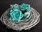 Teal paper flowers on a gray wooden wreath