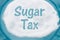 Teal Plate with a lot of sugar with text Sales Tax