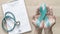 Teal ribbon awareness on woman`s hand for Ovarian Cancer, Polycystic Ovary Syndrome PCOS disease, Post Traumatic Stress Disorder