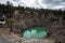 Teal water pool of the Inyo Craters in Mammoth Lakes on a rainy spring day