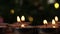 Tealight candles flickering with bokeh background