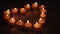 tealight candles in a shape of a heart in slow motion