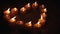 tealight candles in a shape of a heart in slow motion