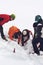 Team of alpine rescuers digging in snow