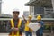 Team of architectures standing at construction site looking at p