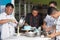 Team of asian male  pastry chef happy work together while preparing batter