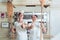 Team of baker women standing in bakery giving thumbs up