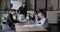 Team of cheerful excited employees meeting at conference table