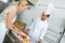 Team chefs chopping vegetables on chopping board in kitchen