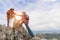 Team of climbers man and woman help each other on top of mountain, climbing hiking together, Young tourists with backpacks