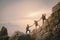 Team of climbers man and woman hiker holding hands to help each other up the hill with red flags for hiking for mountain climbing