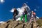 Team of climbers walks against alpine background