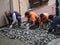 Team Of Construction Workers Building Pavement With Cobblestones