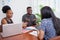 Team of diverse colleagues have heated discussion debate, boardroom table brainstorm