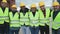 Team of diverse industrial engineers working in logistic terminal of container cargo