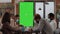 Team of diverse workmates working with vertically green screen