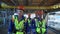 Team engineer metalworker in protective helmet uniform going refinery construction together