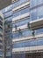 A team of four climbers washes the windows and walls of a multi-story office building