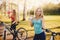 Team of girls bike with bottle of water in park on sunset background