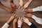Team, hands or peace star sign with diversity teamwork, collaboration or team building on desk in office. Business