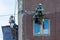 A team of industrial climbers working. A team of industrial climbers making repairs walls of storey house