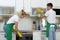 Team of janitors cleaning kitchen