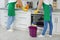 Team of janitors cleaning kitchen